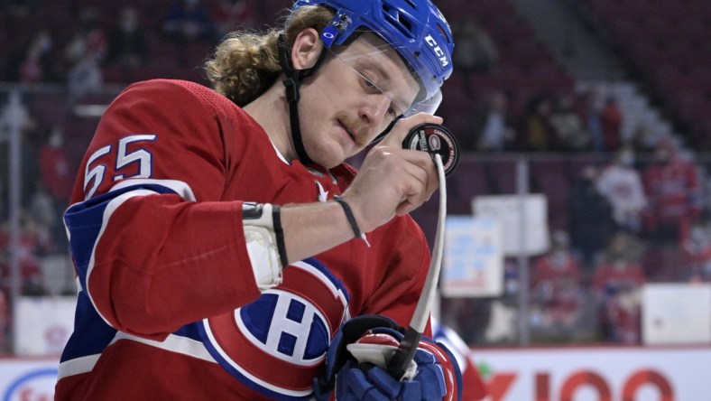 Mar 15, 2022; Montreal, Quebec, CAN; Montreal Canadiens forward Michael Pezzetta (55) adjusts the blade of his stick with a puck during the warmup period before the game against the Arizona Coyotes at the Bell Centre. Mandatory Credit: Eric Bolte-USA TODAY Sports