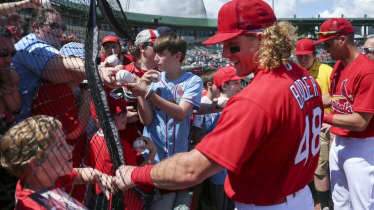 Mar 18, 2022; Jupiter, Florida, USA; St. Louis Cardinals center fielder Harrison Bader (48) reacts with a fan prior to the game against the Houston Astros during spring training at Roger Dean Stadium. Mandatory Credit: Sam Navarro-USA TODAY Sports