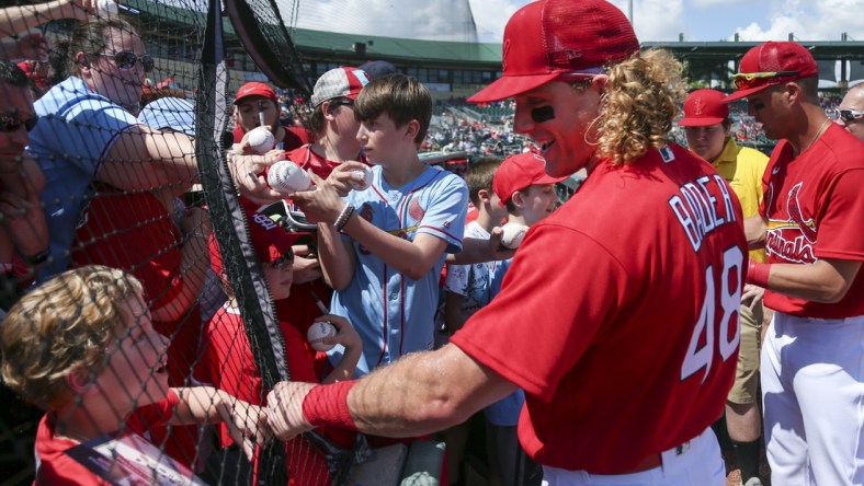 Mar 18, 2022; Jupiter, Florida, USA; St. Louis Cardinals center fielder Harrison Bader (48) reacts with a fan prior to the game against the Houston Astros during spring training at Roger Dean Stadium. Mandatory Credit: Sam Navarro-USA TODAY Sports