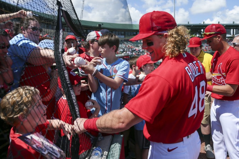 Mar 18, 2022; Jupiter, Florida, USA; St. Louis Cardinals center fielder Harrison Bader (48) reacts with a fan prior to the game against the Houston Astros during spring training at Roger Dean Stadium. Mandatory Credit: Sam Navarro-USA TODAY Sports