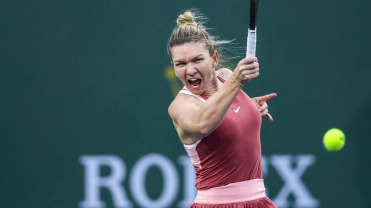 Simona Halep of Romania hits to Iga Swiatek of Poland during the WTA semifinals at the BNP Paribas Open at the Indian Wells Tennis Garden in Indian Wells, Calif., Friday, March 18, 2022.