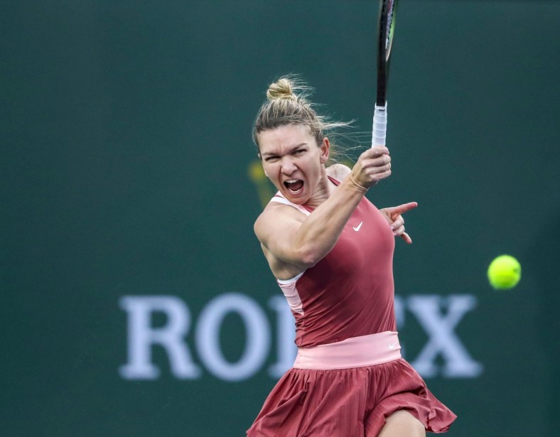 Simona Halep of Romania hits to Iga Swiatek of Poland during the WTA semifinals at the BNP Paribas Open at the Indian Wells Tennis Garden in Indian Wells, Calif., Friday, March 18, 2022.