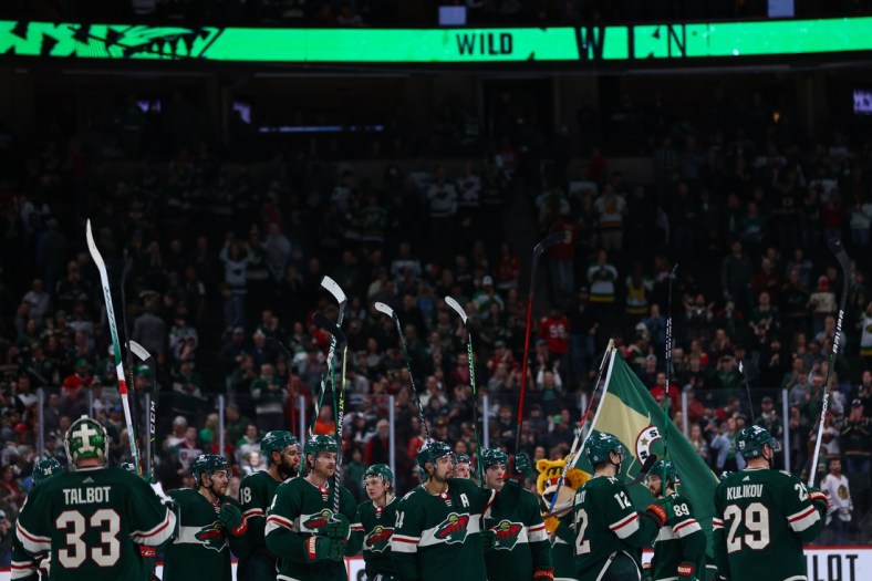 Mar 19, 2022; Saint Paul, Minnesota, USA; Minnesota Wild players acknowledge the fans following their victory over the Chicago Blackhawks at Xcel Energy Center. Mandatory Credit: Harrison Barden-USA TODAY Sports