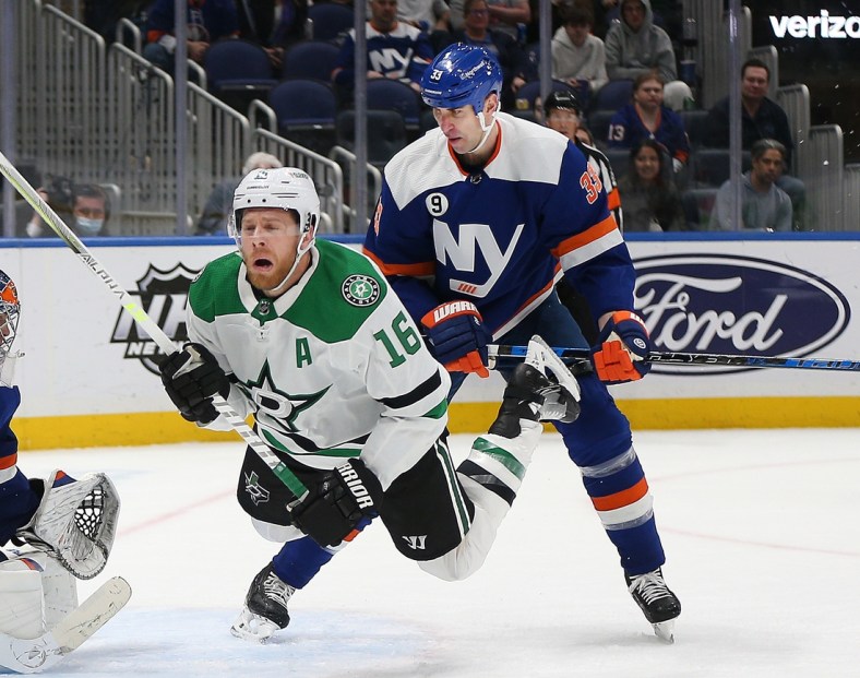 Mar 19, 2022; Elmont, New York, USA; Dallas Stars center Joe Pavelski (16) is checked from behind by New York Islanders defenseman Zdeno Chara (33) during the third period at UBS Arena. Mandatory Credit: Andy Marlin-USA TODAY Sports