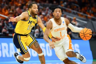 Tennessee guard Kennedy Chandler (1) is defended by Michigan guard DeVante' Jones (12) during the NCAA Tournament second round game between Tennessee and Michigan at Gainbridge Fieldhouse in Indianapolis, Ind., on Saturday, March 19, 2022.Kns Ncaa Vols Michigan Bp