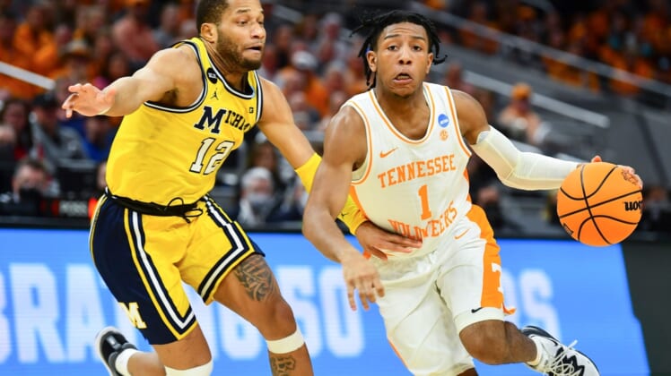 Tennessee guard Kennedy Chandler (1) is defended by Michigan guard DeVante' Jones (12) during the NCAA Tournament second round game between Tennessee and Michigan at Gainbridge Fieldhouse in Indianapolis, Ind., on Saturday, March 19, 2022.Kns Ncaa Vols Michigan Bp