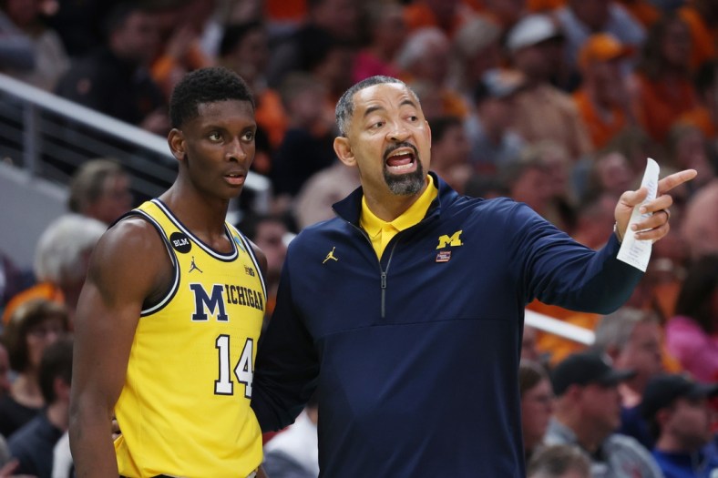 Mar 19, 2022; Indianapolis, IN, USA; Michigan Wolverines head coach Juwan Howard speaks with Michigan Wolverines forward Moussa Diabate (14) in the second half against the Tennessee Volunteers during the second round of the 2022 NCAA Tournament at Gainbridge Fieldhouse. Mandatory Credit: Trevor Ruszkowski-USA TODAY Sports