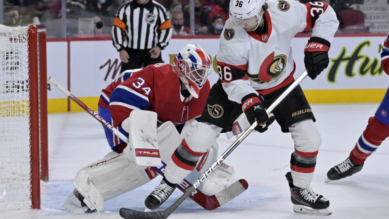 Mar 19, 2022; Montreal, Quebec, CAN; Montreal Canadiens goalie Jake Allen (34) stops Ottawa Senators forward Colin White (36) during the first period at the Bell Centre. Mandatory Credit: Eric Bolte-USA TODAY Sports