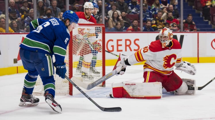 Mar 19, 2022; Vancouver, British Columbia, CAN; Calgary Flames goalie Dan Vladar (80) makes a save against Vancouver Canucks forward Brock Boeser (6) in the third period at Rogers Arena. The Flames won 5-2. Mandatory Credit: Bob Frid-USA TODAY Sports