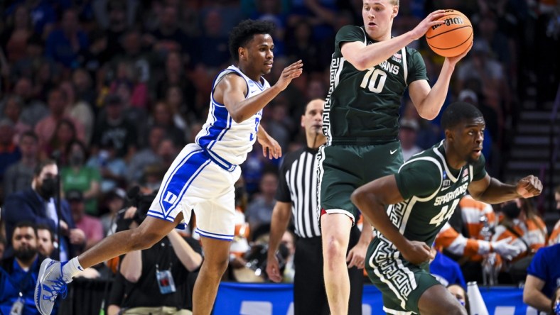 Mar 20, 2022; Greenville, SC, USA; Michigan State Spartans forward Joey Hauser (10) carries the ball against Duke Blue Devils guard Jeremy Roach (3) in the second half during the second round of the 2022 NCAA Tournament at Bon Secours Wellness Arena. Mandatory Credit: Bob Donnan-USA TODAY Sports