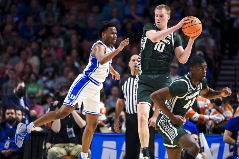 Mar 20, 2022; Greenville, SC, USA; Michigan State Spartans forward Joey Hauser (10) carries the ball against Duke Blue Devils guard Jeremy Roach (3) in the second half during the second round of the 2022 NCAA Tournament at Bon Secours Wellness Arena. Mandatory Credit: Bob Donnan-USA TODAY Sports