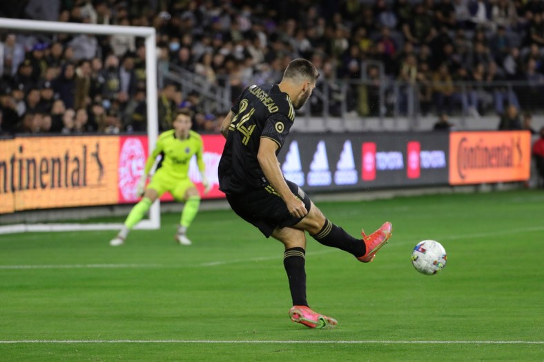 Mar 20, 2022; Los Angeles, California, USA; Los Angeles FC midfielder Ryan Hollingshead (24) passes the ball during the first half against the Vancouver Whitecaps FC at Banc of California Stadium. LAFC won 3-1. Mandatory Credit: Kiyoshi Mio-USA TODAY Sports