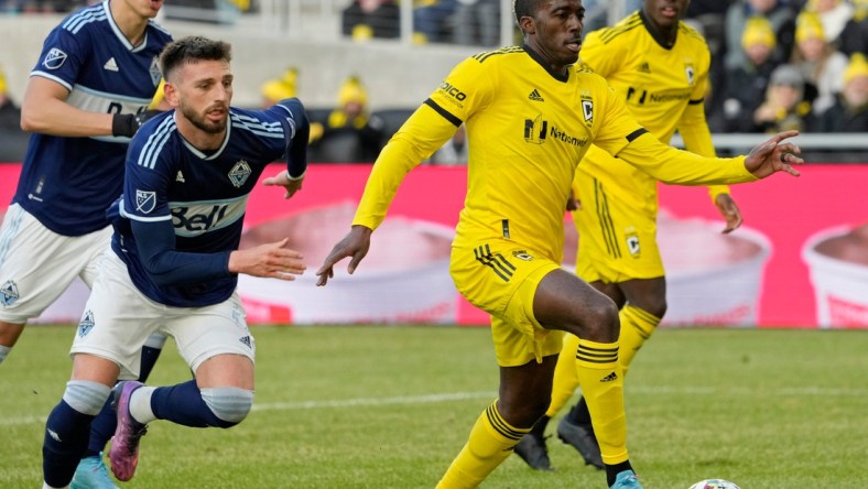 Columbus Crew forward Gyasi Zardes (11) is pursued by Vancouver Whitecaps defender Tristan Blackmon (6) during the second half of Saturday's season opener at Lower.com field in Columbus, Oh., on February 26, 2022.

Ceb Crew 0227 Bjp 39