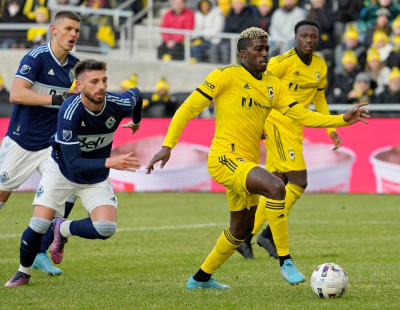 Columbus Crew forward Gyasi Zardes (11) is pursued by Vancouver Whitecaps defender Tristan Blackmon (6) during the second half of Saturday's season opener at Lower.com field in Columbus, Oh., on February 26, 2022.

Ceb Crew 0227 Bjp 39