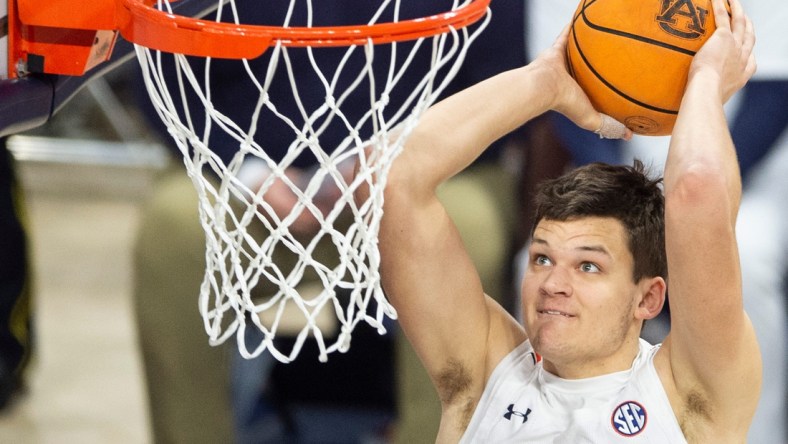 Auburn Tigers player Walker Kessler (13) dunks the ball as Auburn Tigers men's basketball takes on Texas A&M Aggies at Auburn Arena in Auburn, Ala., on Saturday, Feb. 12, 2022. Auburn Tigers defeated Texas A&M Aggies 75-58.