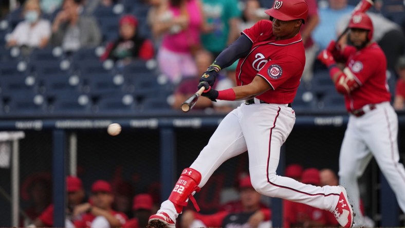 Mar 24, 2022; West Palm Beach, Florida, USA; Washington Nationals right fielder Juan Soto (22) hits an RBI single in the 1st inning of the spring training game against the Houston Astros at The Ballpark of the Palm Beaches. Mandatory Credit: Jasen Vinlove-USA TODAY Sports