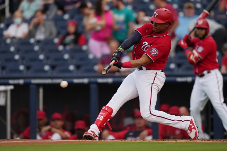 Mar 24, 2022; West Palm Beach, Florida, USA; Washington Nationals right fielder Juan Soto (22) hits an RBI single in the 1st inning of the spring training game against the Houston Astros at The Ballpark of the Palm Beaches. Mandatory Credit: Jasen Vinlove-USA TODAY Sports