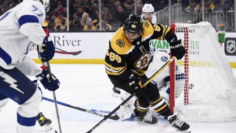 Mar 24, 2022; Boston, Massachusetts, USA;  Boston Bruins right wing David Pastrnak (88) battles for a lose puck with Tampa Bay Lightning defenseman Victor Hedman (77) during the third period at TD Garden. Mandatory Credit: Bob DeChiara-USA TODAY Sports