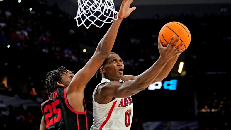 Mar 24, 2022; San Antonio, TX, USA; Arizona Wildcats guard Bennedict Mathurin (0) drives to the basket against Houston Cougars center Josh Carlton (25) during the second half in the semifinals of the South regional of the men's college basketball NCAA Tournament at AT&T Center. Mandatory Credit: Daniel Dunn-USA TODAY Sports