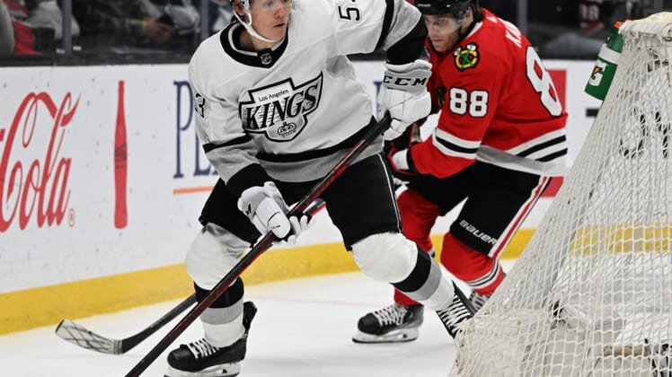 Mar 24, 2022; Los Angeles, California, USA;  Los Angeles Kings defenseman Jordan Spence (53) keeps the puck from Chicago Blackhawks right wing Patrick Kane (88) in the third period at Crypto.com Arena. Mandatory Credit: Jayne Kamin-Oncea-USA TODAY Sports