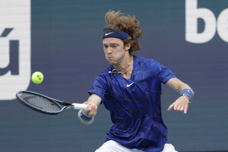 Mar 25, 2022; Miami Gardens, FL, USA; Andrey Rublev hits a forehand against Nick Krygios (not pictured) in a second round men's match in the Miami Open at Hard Rock Stadium. Mandatory Credit: Geoff Burke-USA TODAY Sports
