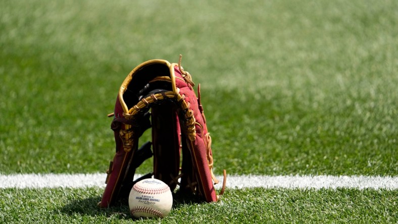 Mar 25, 2022; Scottsdale, Arizona, USA; Arizona Diamondbacks David Peralta leaves his glove and baseball on the turf as he warms-up to play the Los Angeles Angels during a spring training game at Salt River Fields. Mandatory Credit: Rob Schumacher-Arizona RepublicMlb Los Angles Angels At Arizona Diamondbacks