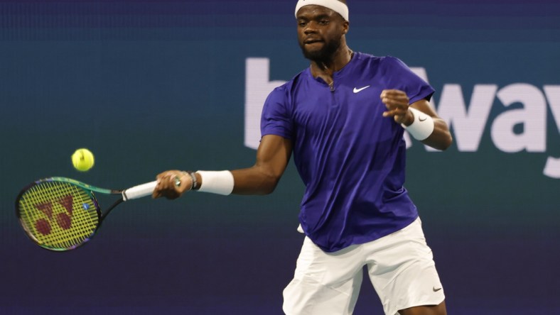 Mar 25, 2022; Miami Gardens, FL, USA; Frances Tiafoe (USA) hits a forehand against Brandon Nakashima (USA) (not pictured) in a second round men's singles match in the Miami Open at Hard Rock Stadium. Mandatory Credit: Geoff Burke-USA TODAY Sports