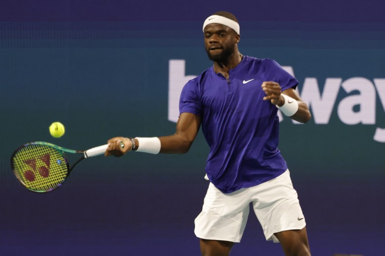 Mar 25, 2022; Miami Gardens, FL, USA; Frances Tiafoe (USA) hits a forehand against Brandon Nakashima (USA) (not pictured) in a second round men's singles match in the Miami Open at Hard Rock Stadium. Mandatory Credit: Geoff Burke-USA TODAY Sports