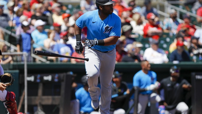 Mar 26, 2022; Jupiter, Florida, USA; Miami Marlins designated hitter Jesus Aguilar (99) watches after connecting for a home run in the first inning of the game against the St. Louis Cardinals during spring training at Roger Dean Stadium. Mandatory Credit: Sam Navarro-USA TODAY Sports