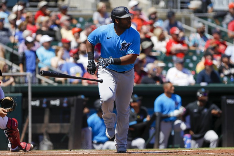 Mar 26, 2022; Jupiter, Florida, USA; Miami Marlins designated hitter Jesus Aguilar (99) watches after connecting for a home run in the first inning of the game against the St. Louis Cardinals during spring training at Roger Dean Stadium. Mandatory Credit: Sam Navarro-USA TODAY Sports
