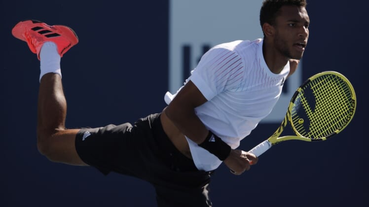 Mar 26, 2022; Miami Gardens, FL, USA; Felix Auger-Aliassime (CAN) serves against Miomir Kecmanovic (SRB)(not pictured) in a second round mens's singles match in the Miami Open at Hard Rock Stadium. Mandatory Credit: Geoff Burke-USA TODAY Sports
