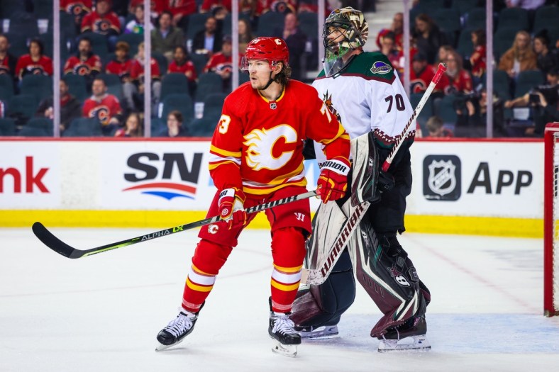 Mar 25, 2022; Calgary, Alberta, CAN; Calgary Flames right wing Tyler Toffoli (73) screens in front of Arizona Coyotes goaltender Karel Vejmelka (70) during the third period at Scotiabank Saddledome. Mandatory Credit: Sergei Belski-USA TODAY Sports
