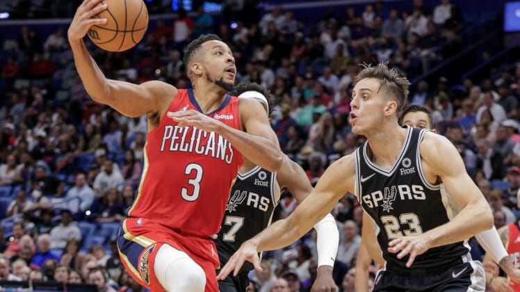 Mar 26, 2022; New Orleans, Louisiana, USA;  New Orleans Pelicans guard CJ McCollum (3) drives to the basket against San Antonio Spurs forward Zach Collins (23) during the second half at the New Orleans Pelicans at the Smoothie King Center. Mandatory Credit: Stephen Lew-USA TODAY Sports