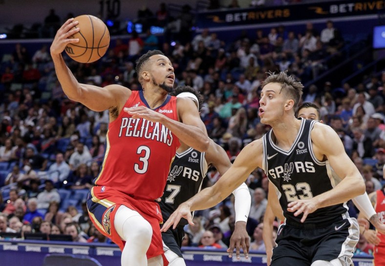 Mar 26, 2022; New Orleans, Louisiana, USA;  New Orleans Pelicans guard CJ McCollum (3) drives to the basket against San Antonio Spurs forward Zach Collins (23) during the second half at the New Orleans Pelicans at the Smoothie King Center. Mandatory Credit: Stephen Lew-USA TODAY Sports
