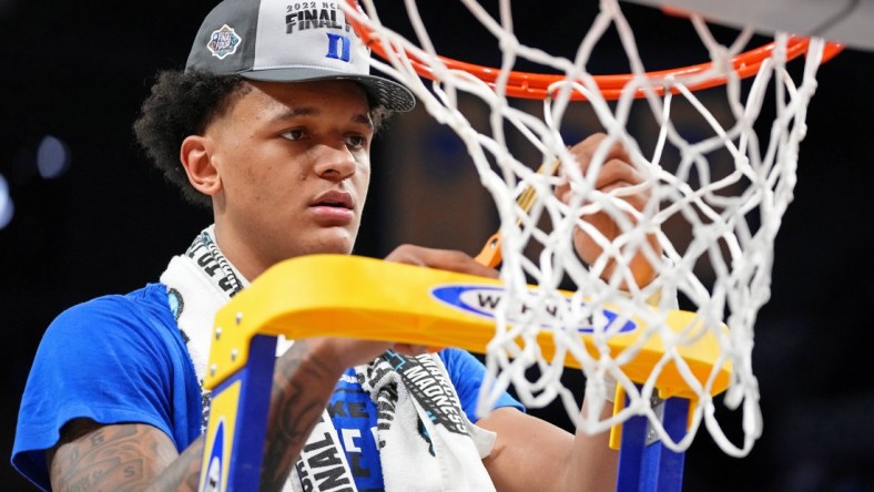 Mar 26, 2022; San Francisco, CA, USA; Duke Blue Devils forward Paolo Banchero (5) cuts a piece of the net as they celebrate their win over the Arkansas Razorbacks in the finals of the West regional of the men's college basketball NCAA Tournament at Chase Center. The Duke Blue Devils won 78-69. Mandatory Credit: Kyle Terada-USA TODAY Sports