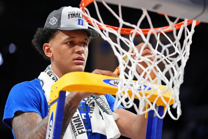 Mar 26, 2022; San Francisco, CA, USA; Duke Blue Devils forward Paolo Banchero (5) cuts a piece of the net as they celebrate their win over the Arkansas Razorbacks in the finals of the West regional of the men's college basketball NCAA Tournament at Chase Center. The Duke Blue Devils won 78-69. Mandatory Credit: Kyle Terada-USA TODAY Sports