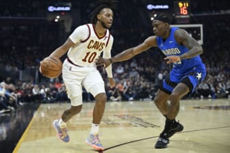 Mar 28, 2022; Cleveland, Ohio, USA; Cleveland Cavaliers guard Darius Garland (10) dribbles the ball beside Orlando Magic forward Admiral Schofield (25) in the second quarter at Rocket Mortgage FieldHouse. Mandatory Credit: David Richard-USA TODAY Sports