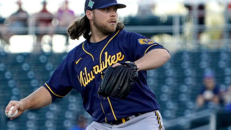 Corbin Burnes delivers a pitch during a Brewers spring training game against the Cincinnati Reds, Wednesday, March 23, 2022, at Goodyear Ballpark in Goodyear, Ariz.

Syndication The Enquirer