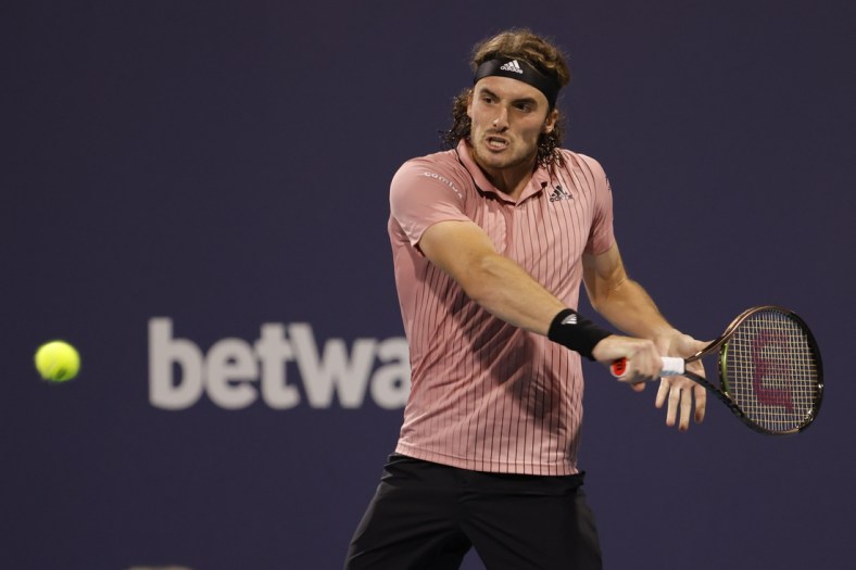 Mar 29, 2022; Miami Gardens, FL, USA; Stefanos Tsitsipas (GRE) hits a backhand against Carlos Alcaraz (ESP)(not pictured) in a men's fourth round men's singles match in the Miami Open at Hard Rock Stadium. Mandatory Credit: Geoff Burke-USA TODAY Sports