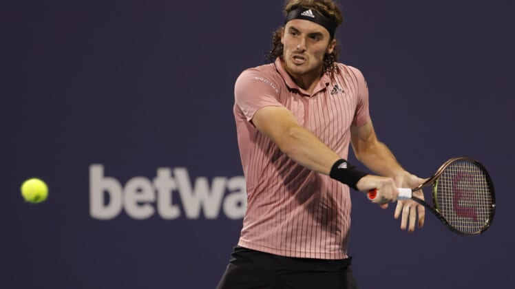 Mar 29, 2022; Miami Gardens, FL, USA; Stefanos Tsitsipas (GRE) hits a backhand against Carlos Alcaraz (ESP)(not pictured) in a men's fourth round men's singles match in the Miami Open at Hard Rock Stadium. Mandatory Credit: Geoff Burke-USA TODAY Sports