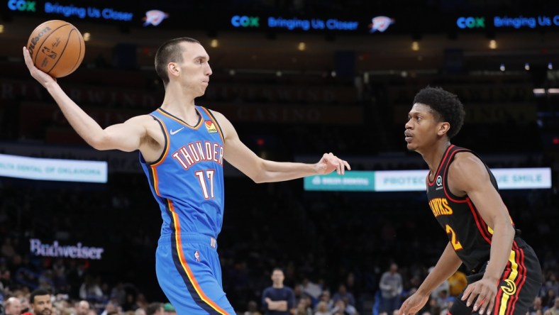 Mar 30, 2022; Oklahoma City, Oklahoma, USA; Oklahoma City Thunder center Aleksej Pokusevski (17) passes the ball as Atlanta Hawks guard Sharife Cooper (2) looks on during the second half at Paycom Center. Mandatory Credit: Alonzo Adams-USA TODAY Sports