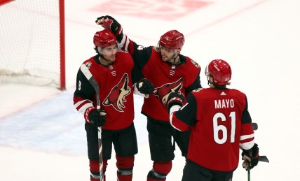 Mar 30, 2022; Glendale, Arizona, USA; Arizona Coyotes center Nick Schmaltz (8) , defenseman Shayne Gostisbehere (14) , defenseman Dysin Mayo (61) celebrate their 5-2 victory over the San Jose Sharks at Gila River Arena. Mandatory Credit: Mark J. Rebilas-USA TODAY Sports