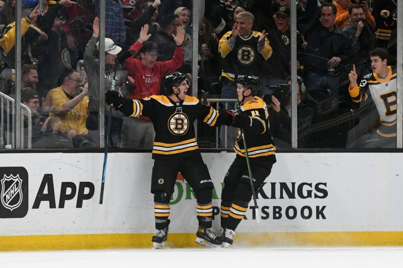 Mar 31, 2022; Boston, Massachusetts, USA; Boston Bruins center Marc McLaughlin (26) celebrates with center Trent Frederic (11) after scoring his first NHL goal against the New Jersey Devils during the second period at the TD Garden. Mandatory Credit: Brian Fluharty-USA TODAY Sports