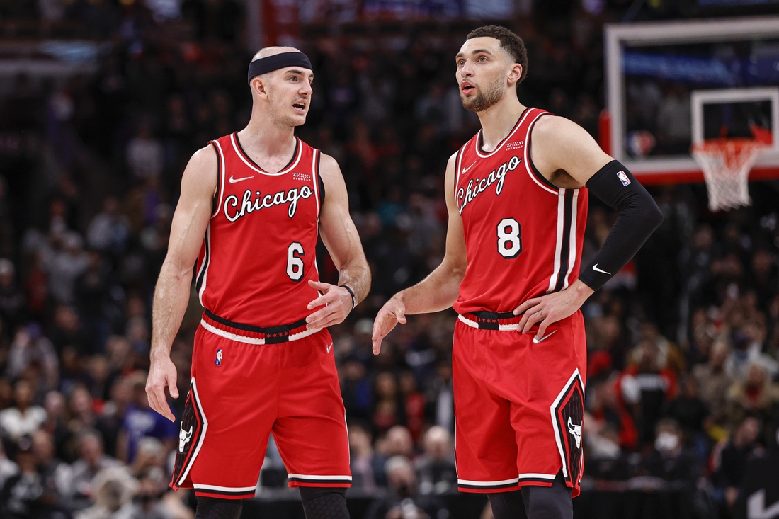 Mar 31, 2022; Chicago, Illinois, USA; Chicago Bulls guard Alex Caruso (6) talks with guard Zach LaVine (8) during overtime of an NBA game against the LA Clippers at United Center. Mandatory Credit: Kamil Krzaczynski-USA TODAY Sports