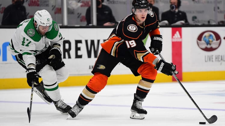 Mar 31, 2022; Anaheim, California, USA; Anaheim Ducks right wing Troy Terry (19) moves the puck ahead of Dallas Stars right wing Alexander Radulov (47) during the third period at Honda Center. Mandatory Credit: Gary A. Vasquez-USA TODAY Sports
