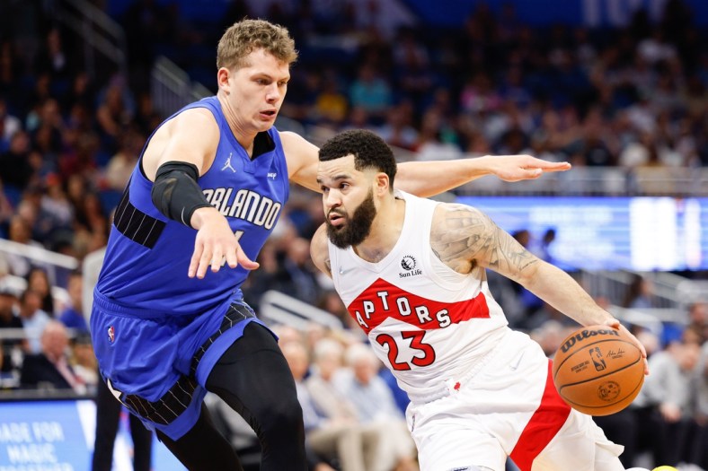 Apr 1, 2022; Orlando, Florida, USA;  Toronto Raptors guard Fred VanVleet (23) moves to the basket against Orlando Magic center Moritz Wagner (21) in the first quarter at Amway Center. Mandatory Credit: Nathan Ray Seebeck-USA TODAY Sports