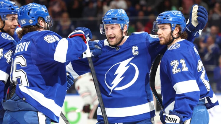 Apr 1, 2022; Tampa, Florida, USA;Tampa Bay Lightning center Steven Stamkos (91) is congratulated by defenseman Victor Hedman (77), center Brayden Point (21), left wing Pierre-Edouard Bellemare (41) and right wing Nikita Kucherov (86) after a goal during the first period against the Chicago Blackhawks at Amalie Arena. Mandatory Credit: Kim Klement-USA TODAY Sports
