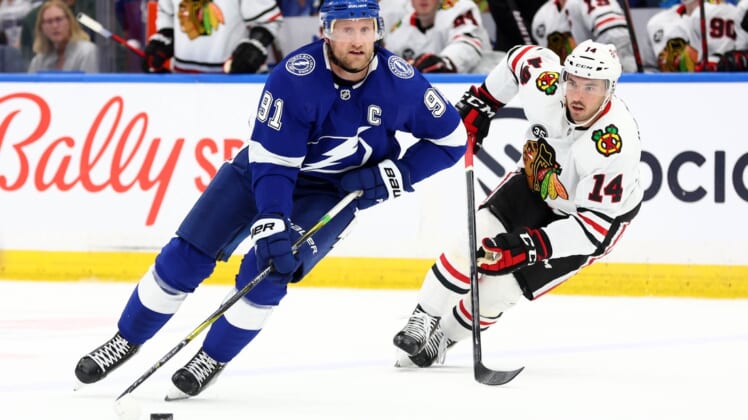 Apr 1, 2022; Tampa, Florida, USA; Tampa Bay Lightning center Steven Stamkos (91) skates with the puck as Chicago Blackhawks left wing Boris Katchouk (14) defends during the first period at Amalie Arena. Mandatory Credit: Kim Klement-USA TODAY Sports
