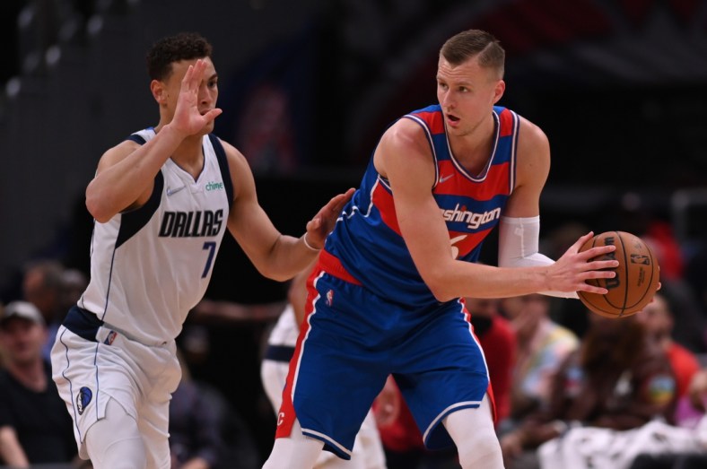 Apr 1, 2022; Washington, District of Columbia, USA; Washington Wizards center Kristaps Porzingis (6) looks to pass as Dallas Mavericks center Dwight Powell (7) defends during the first half at Capital One Arena. Mandatory Credit: Tommy Gilligan-USA TODAY Sports