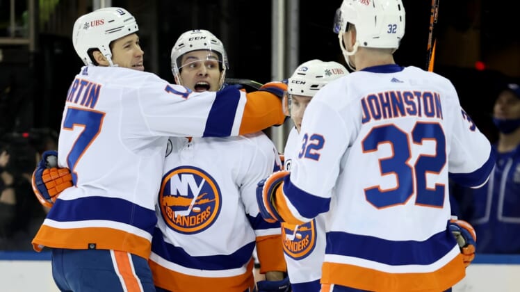 Apr 1, 2022; New York, New York, USA; New York Islanders left wing Matt Martin (17) celebrates his goal against the New York Rangers with center Mathew Barzal (13) and defenseman Sebastian Aho (25) and left wing Ross Johnston (32) during the second period at Madison Square Garden. Mandatory Credit: Brad Penner-USA TODAY Sports